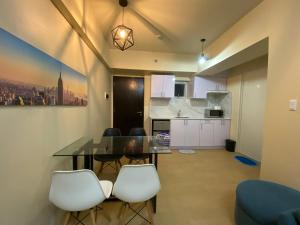 a kitchen and dining room with a table and chairs at 1 Bedroom Condo Unit at Centrio Tower in Cagayan de Oro