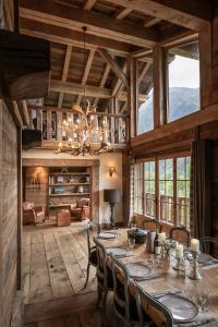 a large dining room with a table and chairs at Chalet Ruitor, chalet 500 m2 luxueux de caractère in Sainte-Foy-Tarentaise