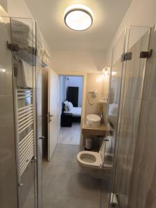 a bathroom with a toilet and a shower and a sink at Romana Residence in Bucharest