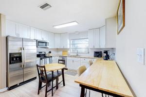 Una cocina con una mesa y un refrigerador de acero inoxidable. en Crawford Street Home, en Lakeland