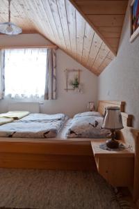 a bedroom with a large bed and a window at Appartementhaus Parzer in Pruggern