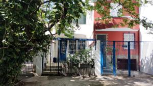 a blue gate in front of a house at Farfalla São Manuel in Rio de Janeiro