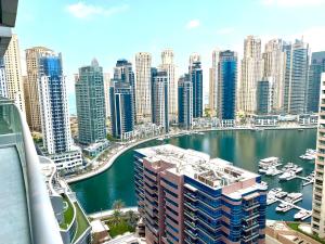 a view of a city with boats in a harbor at The Waves 241 Dubai Marina in Dubai