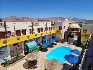 an aerial view of a hotel with umbrellas and tables at Delta Dahab Hotel in Dahab