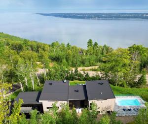an aerial view of a house with a swimming pool at Panorama Charlevoix - Pool, Spa, Exceptional View in Les Éboulements
