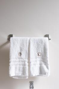 a towel hanging on a towel rack in a bathroom at Oronti Accommodations in Lecce