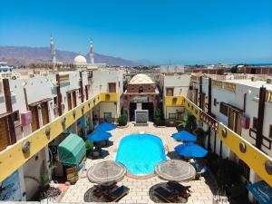 an overhead view of a courtyard with umbrellas and a swimming pool at Delta Dahab Hotel in Dahab
