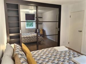 a room with a bed and a mirror in a room at Regents Park Area in London