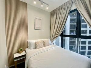 a bedroom with a large white bed and a window at Stylish Nordic Suite, Pool View, 500mbps, GEO Bukit Rimau, Kota Kemuning in Shah Alam