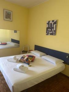 a bedroom with two beds with towels on them at FEEL - Borgo Palazzo Apartment in Bergamo