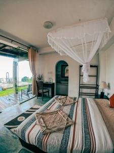 a bedroom with a large bed with a canopy at Hill Safari - Tea Estate Villa in Ohiya
