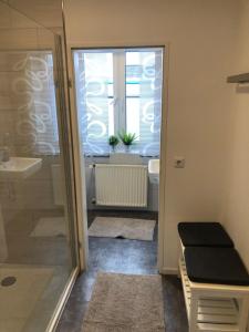 a bathroom with a shower and a toilet and a sink at Ferienwohnung bei Jennifer in Gütersloh