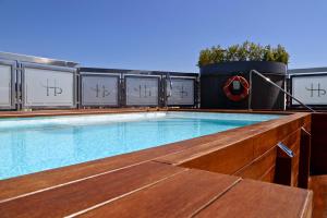 a swimming pool on the roof of a building at LHP Napoli Palace & SPA in Naples