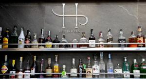 a shelf filled with lots of bottles of alcohol at LHP Napoli Palace & SPA in Naples