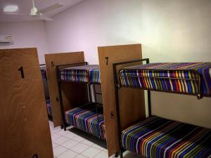 a row of bunk beds in a room at Huitzilin Hostal in Brisas de Zicatela