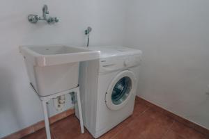 a white washing machine and a sink in a bathroom at Vivienda Turística Sunbeach-Xilxes VT-42192-CS in Xilxes