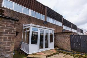 a brick building with a white door in front of it at Stridingedge - 3 Bedroom 5 beds Sleeps 6 Ideal For Contractors in Washington