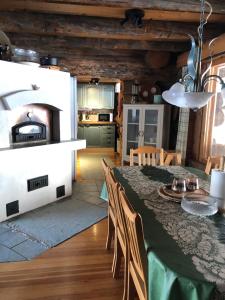 a kitchen and dining room with a table and a pizza oven at Villa Kuiske in Kuusamo