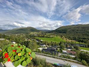 a view of a town with mountains in the background at Apartment in Astrup’s Kingdom in Vassenden