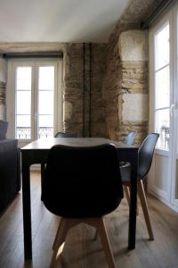 comedor con mesa negra y sillas en Apartamentos FOROPLAZA, en Lugo