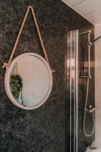 a mirror hanging on a wall in a bathroom at Alice - spacious 3 bedroom house contractor accommodation in Sunderland