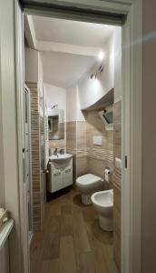 a bathroom with a toilet and a sink at Martinahouse in Vico nel Lazio