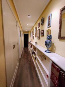 a hallway with a long shelf with a vase on it at La Elegancia del Centro by Alogest in Zaragoza