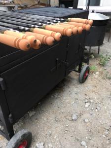 a black barbecue cart with hot dogs on it at Old House Gyumri in Gyumri