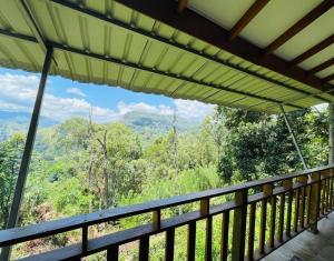 a balcony with a view of the mountains at Racy Nature Cottage in Ella