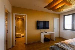 a bedroom with a flat screen tv on the wall at Rezidence Eliška in Prague