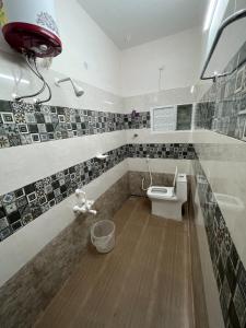 La salle de bains est pourvue de toilettes et d'un lavabo. dans l'établissement SAN BEACH RESIDENCY, à Karikal