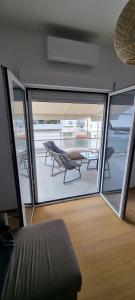 a room with a view of a balcony with a table at New house in Pireas port in Piraeus