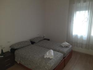 une chambre avec deux lits et une fenêtre dans l'établissement Spazioso Appartamento in casa singola Padova con giardino, à Padoue