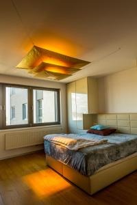 a bedroom with a bed and a large window at Rezidence Eliška in Prague