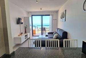 een woonkamer met een bank en een tafel bij Sea view cozy apartment La Tanita in Mojácar