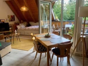a living room with a wooden table and chairs at FeWo Fuchs Saig in Lenzkirch