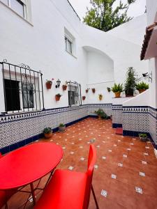 a patio with a red table and chairs at Escuela Village in Marbella