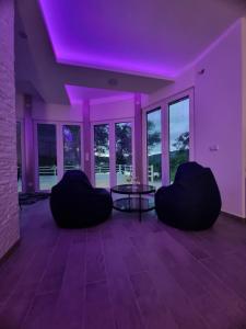 a living room with purple lights on the ceiling at Vikendica River Drina - Mali Zvornik-Velika Reka in Podrebelj