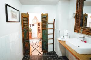 a bathroom with a sink and a mirror at La Ferme Medina in Marrakesh