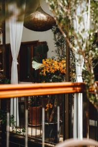 a reflection of a balcony with flowers in a window at La Ferme Medina in Marrakech