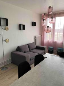 un soggiorno con un divano e un tavolo di Bel appartement centre ville de Vierzon a Vierzon