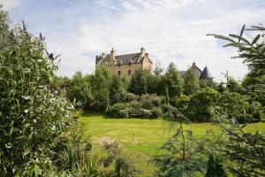 an old castle in the middle of a garden at The Tower at Plane Castle in Stirling