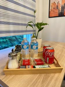 a tray with drinks and water bottles on a table at Central London - Edgware Road 2 BEDROOMS FLAT in London