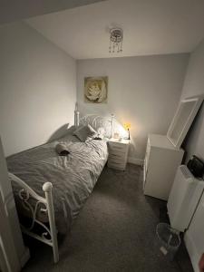 a bedroom with a white bed and a nightstand and a bed sidx sidx sidx at Central London - Edgware Road 2 BEDROOMS FLAT in London