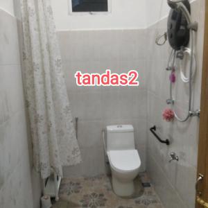 a small bathroom with a toilet and a shower at Raptronics Homestay Kampung in Kota Bharu +10 photos