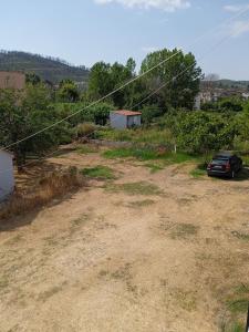 an empty yard with a car parked in it at PANAGIOTIS in Pefki