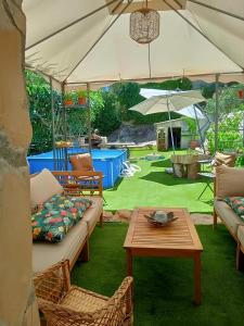patio z kanapami, stołem i parasolem w obiekcie Can Pavet w mieście Pontons