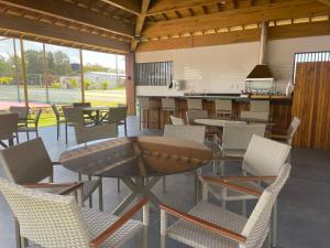 een patio met tafels en stoelen en een aanrecht bij INCRIVEL apartamento com vista lago! in Praia do Forte