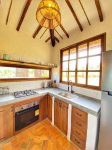 una cucina con lavandino e frigorifero di Cabaña Villa Chelita descanso y confort. a Barichara