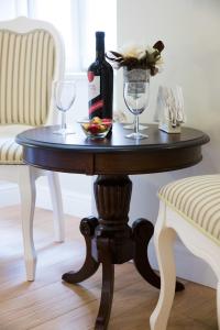 a table with a bottle of wine and two glasses at Studio Apartments Sonatina in Dubrovnik